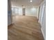 Open-concept living space featuring new floors, fresh paint, and modern lighting at 11210 Yewtree Ave, Port Richey, FL 34668