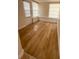 Sun room with multiple windows, white trim, and oak colored vinyl wood floors at 11210 Yewtree Ave, Port Richey, FL 34668