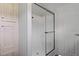 The modern shower has a sliding glass door, and built in shelving at 11309 Tulane St, New Port Richey, FL 34654