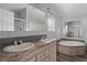 This bathroom features dual sinks, grey backsplash tile, and a jetted tub at 11309 Tulane St, New Port Richey, FL 34654