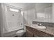 Bathroom featuring a shower-tub combo, granite vanity, and grey subway tile backsplash at 11309 Tulane St, New Port Richey, FL 34654