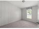 Neutral bedroom with carpet, one window, and light walls ready for your personal touches at 11309 Tulane St, New Port Richey, FL 34654