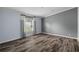 This bedroom features luxury vinyl flooring and grey accent walls at 11309 Tulane St, New Port Richey, FL 34654