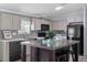 Modern kitchen with stainless steel appliances, a center island, and attractive backsplash at 11309 Tulane St, New Port Richey, FL 34654