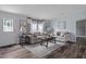 Inviting living room with comfortable seating, stylish decor, and wood-look flooring at 11309 Tulane St, New Port Richey, FL 34654