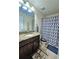 Bathroom featuring a granite vanity and patterned shower curtain at 11936 Sand Myrtle Rd, Riverview, FL 33579