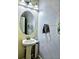Well-lit half-bathroom with pedestal sink and textured walls, offering a clean and modern aesthetic at 11936 Sand Myrtle Rd, Riverview, FL 33579