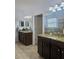 Modern bathroom featuring double vanity, granite countertops, and large mirrors at 11936 Sand Myrtle Rd, Riverview, FL 33579