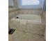 Bathroom with a built-in bathtub and neutral tile surround at 11936 Sand Myrtle Rd, Riverview, FL 33579