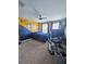 View of a bedroom with a ceiling fan and a bed with blue covers at 11936 Sand Myrtle Rd, Riverview, FL 33579