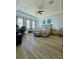 Spacious bedroom with wood-look tile floors, ceiling fan, and abundant natural light at 11936 Sand Myrtle Rd, Riverview, FL 33579