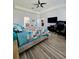 Primary bedroom with wood-look tile flooring, neutral walls, and a ceiling fan at 11936 Sand Myrtle Rd, Riverview, FL 33579