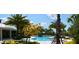 Inviting community pool area featuring palm trees, shaded seating, and beautiful landscaping for relaxation at 11936 Sand Myrtle Rd, Riverview, FL 33579