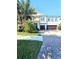 Charming two-story home with a well manicured lawn and a large driveway leading to a two car garage at 11936 Sand Myrtle Rd, Riverview, FL 33579