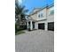 Inviting home with a two-car garage, a covered porch with columns, and a beautifully bricked driveway at 11936 Sand Myrtle Rd, Riverview, FL 33579
