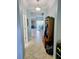 Inviting hallway with tile flooring and a view into a spacious living area bathed in natural light at 11936 Sand Myrtle Rd, Riverview, FL 33579