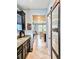 Hallway with an open view of a kitchen and dining area, seamlessly connected by stylish flooring at 11936 Sand Myrtle Rd, Riverview, FL 33579