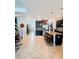 View of the kitchen and stairs, featuring dark cabinets, center island with stools, and tile flooring at 11936 Sand Myrtle Rd, Riverview, FL 33579