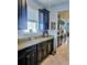 Modern kitchen featuring black cabinetry, granite countertops, and stainless steel appliances at 11936 Sand Myrtle Rd, Riverview, FL 33579