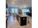 Open-concept kitchen with an island, which adjoins the dining area and living room at 11936 Sand Myrtle Rd, Riverview, FL 33579