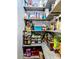 Pantry featuring organized shelving, canned goods, containers and colorful backsplash at 11936 Sand Myrtle Rd, Riverview, FL 33579
