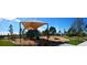 Covered playground with slides, swings, and a soft landing area, great for and outdoor fun at 11936 Sand Myrtle Rd, Riverview, FL 33579