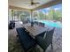 View of an outdoor dining table on a screened in patio, next to a beautiful pool at 11936 Sand Myrtle Rd, Riverview, FL 33579