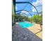 View of a beautiful pool with screened in patio and landscaped yard at 11936 Sand Myrtle Rd, Riverview, FL 33579