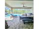 View of an outdoor dining table on a screened in patio, next to a beautiful pool at 11936 Sand Myrtle Rd, Riverview, FL 33579