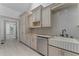 Traditional kitchen with cream-colored cabinets, stone countertops, and stainless steel appliances at 1330 Cherry Ne St, St Petersburg, FL 33701