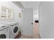Convenient laundry room featuring modern washer and dryer with bright light at 1330 Cherry Ne St, St Petersburg, FL 33701