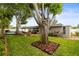 Spacious backyard featuring a well-maintained lawn, mature trees, patio, and a refreshing pool for outdoor enjoyment at 13841 89Th Ave, Seminole, FL 33776