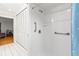 Clean bathroom with hand rails, shower, and white tile floors at 13841 89Th Ave, Seminole, FL 33776