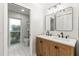 Updated bathroom featuring double sinks and a walk in shower at 13841 89Th Ave, Seminole, FL 33776