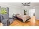 Comfortable bedroom featuring a recliner, hardwood floors, and natural light at 13841 89Th Ave, Seminole, FL 33776