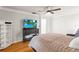 Cozy bedroom with hardwood floors, ceiling fan, and TV at 13841 89Th Ave, Seminole, FL 33776
