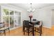 Cozy dining area featuring hardwood floors, a modern chandelier, and bright natural light at 13841 89Th Ave, Seminole, FL 33776