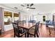 An elegant dining room featuring hardwood floors and seamless flow into the living area at 13841 89Th Ave, Seminole, FL 33776