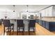 Bright kitchen featuring bar seating, two-toned cabinetry, granite countertops, and hardwood floors at 13841 89Th Ave, Seminole, FL 33776