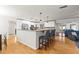Bright, open kitchen with hardwood floors, granite countertops, stainless steel appliances and counter seating at 13841 89Th Ave, Seminole, FL 33776