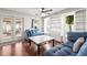 Relaxing living room with hardwood floors, ceiling fan, built-in shelves, and comfortable seating at 13841 89Th Ave, Seminole, FL 33776
