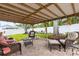 Brick-paved patio covered by a pergola, surrounded by well-maintained landscaping at 13841 89Th Ave, Seminole, FL 33776