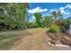 Expansive backyard with lush greenery, offering plenty of space for outdoor activities at 1402 Bluewater Dr, Sun City Center, FL 33573