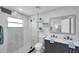 Modern bathroom showcasing a double vanity, a glass-enclosed shower, and stylish tile work at 1402 Bluewater Dr, Sun City Center, FL 33573