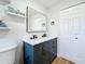 Bathroom featuring double vanity with black hardware, floating shelves, and tile flooring at 1402 Bluewater Dr, Sun City Center, FL 33573