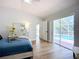Bright bedroom with a view of the pool, providing seamless indoor-outdoor living at 1402 Bluewater Dr, Sun City Center, FL 33573