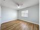 Bedroom featuring laminate floors, white walls, white trim, and a window at 1402 Bluewater Dr, Sun City Center, FL 33573