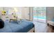 Comfortable bedroom with a sliding glass door, offering a view of the outdoor pool and lush backyard at 1402 Bluewater Dr, Sun City Center, FL 33573