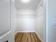Walk-in closet featuring laminate floors, white walls, and wire shelving at 1402 Bluewater Dr, Sun City Center, FL 33573