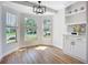 Bright dining area features wood floors, built in cabinet, and large windows at 1402 Bluewater Dr, Sun City Center, FL 33573